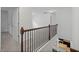 Bright hallway with hardwood railing, white doors, and neutral carpet at 3805 Alden Pl, Cumming, GA 30028