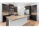 Modern kitchen with granite countertops, stainless steel appliances, and a large island at 3805 Alden Pl, Cumming, GA 30028
