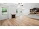 Spacious open-plan living room flows into a kitchen with modern fireplace and access to the backyard at 3805 Alden Pl, Cumming, GA 30028
