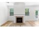 Bright living room offers a tiled fireplace, windows and glass panel door to bring nature indoors at 3805 Alden Pl, Cumming, GA 30028