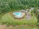 Aerial view of community pool with ample green space, play area, and cabana at 3805 Alden Pl, Cumming, GA 30028