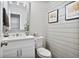 Updated powder room featuring shiplap wall, floating vanity and a decorative mirror at 565 Barsham Way, Johns Creek, GA 30097
