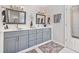 Main bathroom features an updated vanity with double sinks, framed mirrors, and modern lighting at 565 Barsham Way, Johns Creek, GA 30097