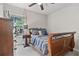 Bedroom with hardwood sleigh bed, dark wood dresser, and a window view at 565 Barsham Way, Johns Creek, GA 30097