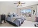 Bedroom with a ceiling fan and a large window offering natural light at 565 Barsham Way, Johns Creek, GA 30097