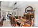 Dining room with wooden table, seating for seven, bay window, and decorative hutch at 565 Barsham Way, Johns Creek, GA 30097