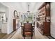 Dining room with wooden table, seating for seven, bay window, and decorative hutch at 565 Barsham Way, Johns Creek, GA 30097