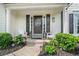Cozy front porch with white Adirondack chairs, beautiful shrubs and custom front door at 565 Barsham Way, Johns Creek, GA 30097