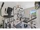 Home gym featuring an elliptical, weight machines, free weights, and a ceiling fan at 565 Barsham Way, Johns Creek, GA 30097