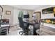 Well-lit home office with desk, laminate floors, computer setup and large window at 565 Barsham Way, Johns Creek, GA 30097