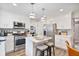 Updated kitchen featuring white cabinets, stainless steel appliances and a center island with seating at 565 Barsham Way, Johns Creek, GA 30097