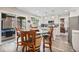 Eat-in kitchen featuring updated appliances, center island and view to screened porch for outdoor dining at 565 Barsham Way, Johns Creek, GA 30097