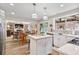 Open kitchen featuring white cabinetry, an island, stainless appliances, and breakfast area at 565 Barsham Way, Johns Creek, GA 30097