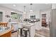 Bright kitchen featuring white cabinetry, an island, stainless appliances, and breakfast area at 565 Barsham Way, Johns Creek, GA 30097