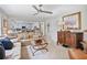 Open concept living room provides a view to the kitchen with stainless steel appliances and white cabinetry at 565 Barsham Way, Johns Creek, GA 30097