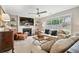 Inviting living room with fireplace and large windows offering plenty of natural light at 565 Barsham Way, Johns Creek, GA 30097