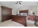 Comfortable main bedroom features a large bed frame, carpet and side tables with lamps at 565 Barsham Way, Johns Creek, GA 30097