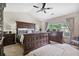 Main bedroom featuring large furniture, carpet, ceiling fan and many windows for natural light at 565 Barsham Way, Johns Creek, GA 30097