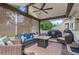 Covered outdoor patio with wicker furniture, a ceiling fan, and a built-in grill at 565 Barsham Way, Johns Creek, GA 30097