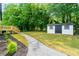 Lush backyard with a stone pathway, shed, and stairs leading to a deck, perfect for outdoor enjoyment at 6054 Heritage Se Way, Mableton, GA 30126