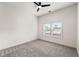 Bright bedroom with neutral walls, gray carpet, and ceiling fan, offering a calm and inviting space at 6054 Heritage Se Way, Mableton, GA 30126