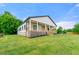 Landscaped yard surrounds this charming home with a covered front porch and brick foundation at 6054 Heritage Se Way, Mableton, GA 30126
