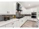 Modern kitchen featuring white cabinets, gray backsplash, quartz countertops, and stainless appliances at 6054 Heritage Se Way, Mableton, GA 30126