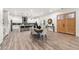 Open-concept living area featuring modern kitchen, dining space, and wooden double doors at 6054 Heritage Se Way, Mableton, GA 30126