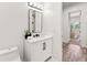 Stylish powder room with a modern vanity, black fixtures, and elegant decor at 6054 Heritage Se Way, Mableton, GA 30126