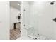 Contemporary walk-in shower featuring a sleek glass enclosure, mosaic flooring and bench seating at 6054 Heritage Se Way, Mableton, GA 30126