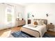 Bright bedroom with hardwood floors, large window, and a view to the bathroom at 629 Hansell Se St, Atlanta, GA 30312