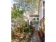 Exterior back view with a stone walkway leading to a backyard entrance and garden at 629 Hansell Se St, Atlanta, GA 30312