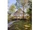 Charming home with a wooden deck, lush greenery, and a stone pathway to the front at 629 Hansell Se St, Atlanta, GA 30312