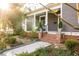 Charming home with mature landscaping, a cozy porch, and accessible ramp at 629 Hansell Se St, Atlanta, GA 30312