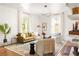 Inviting living room with large windows, hardwood floors, neutral furniture, and modern shelving at 629 Hansell Se St, Atlanta, GA 30312