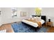 Sunlit bedroom featuring a large bed, modern rug, and windows with natural light at 629 Hansell Se St, Atlanta, GA 30312