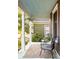 Relaxing front porch with comfortable seating and a decorative painted ceiling at 629 Hansell Se St, Atlanta, GA 30312