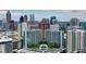 Stunning aerial view of luxury high-rise condominiums and the city skyline with rooftop pool and lush landscaping at 950 W Peachtree Nw St # 1613, Atlanta, GA 30309