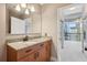 Bright bathroom featuring granite counters, sleek cabinets, and a large mirror over the vanity at 950 W Peachtree Nw St # 1613, Atlanta, GA 30309