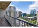 Balcony view featuring modern buildings, trees, and city streets under a bright sky at 950 W Peachtree Nw St # 1613, Atlanta, GA 30309