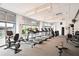 Bright community gym featuring treadmills, ellipticals, and other fitness equipment for resident use at 950 W Peachtree Nw St # 1613, Atlanta, GA 30309