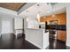 Kitchen boasts stainless appliances, dark wood floors and modern cabinetry and convenient breakfast bar at 950 W Peachtree Nw St # 1613, Atlanta, GA 30309