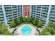 Aerial view of a community pool with lounge chairs surrounded by high-rise buildings at 950 W Peachtree Nw St # 1613, Atlanta, GA 30309