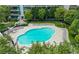 Aerial view of community pool, lounge chairs, and mature landscaping at 950 W Peachtree Nw St # 1613, Atlanta, GA 30309