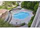 Aerial view of a unique clover-shaped pool surrounded by lounge chairs and landscaping at 950 W Peachtree Nw St # 1613, Atlanta, GA 30309