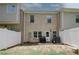 Cozy backyard featuring a white fence, grill and direct access to the home's back door at 10162 Benton Woods Dr, Covington, GA 30014