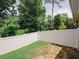 Fenced backyard featuring a well-maintained lawn and privacy with a gate entrance at 10162 Benton Woods Dr, Covington, GA 30014