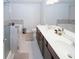 Bathroom featuring double sinks, soaking tub, and separate glass shower at 10162 Benton Woods Dr, Covington, GA 30014