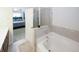 Bathroom featuring soaking tub, glass shower, and an open doorway at 10162 Benton Woods Dr, Covington, GA 30014