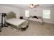 Neutral bedroom with a large bed, a daybed, and plenty of natural light from two windows at 10162 Benton Woods Dr, Covington, GA 30014